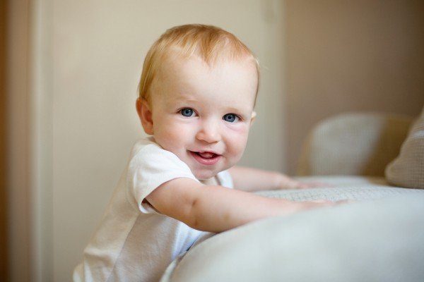 When do babies stand up?