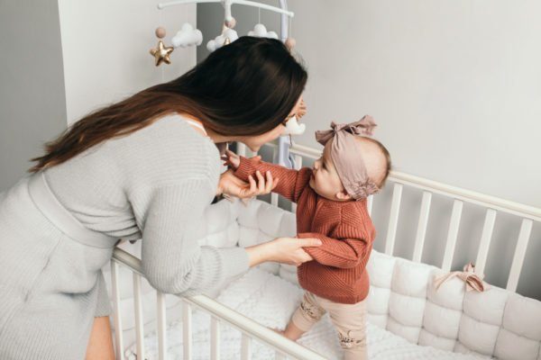How can I help my baby stand up?