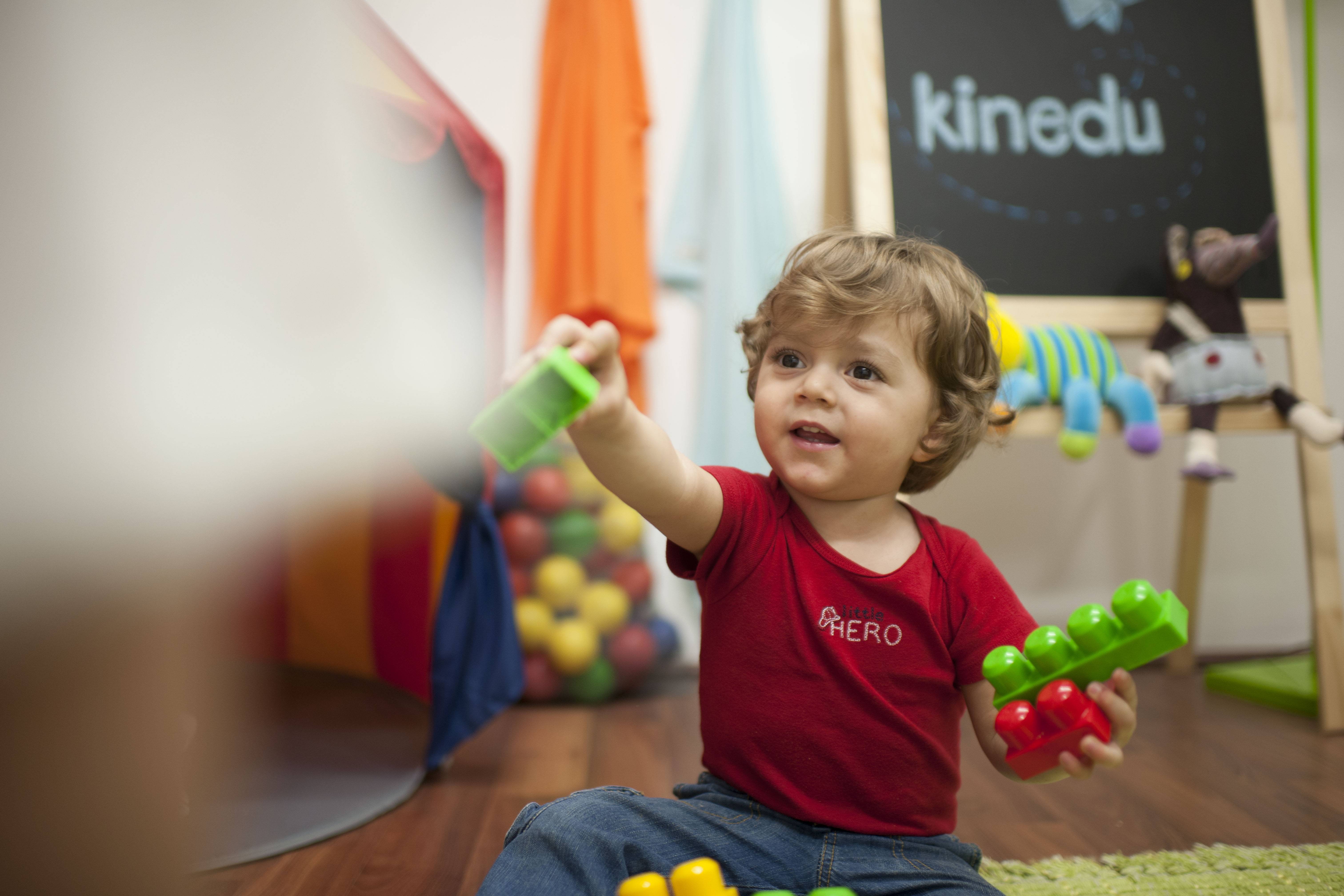 Baby boy playing with plastic blocks