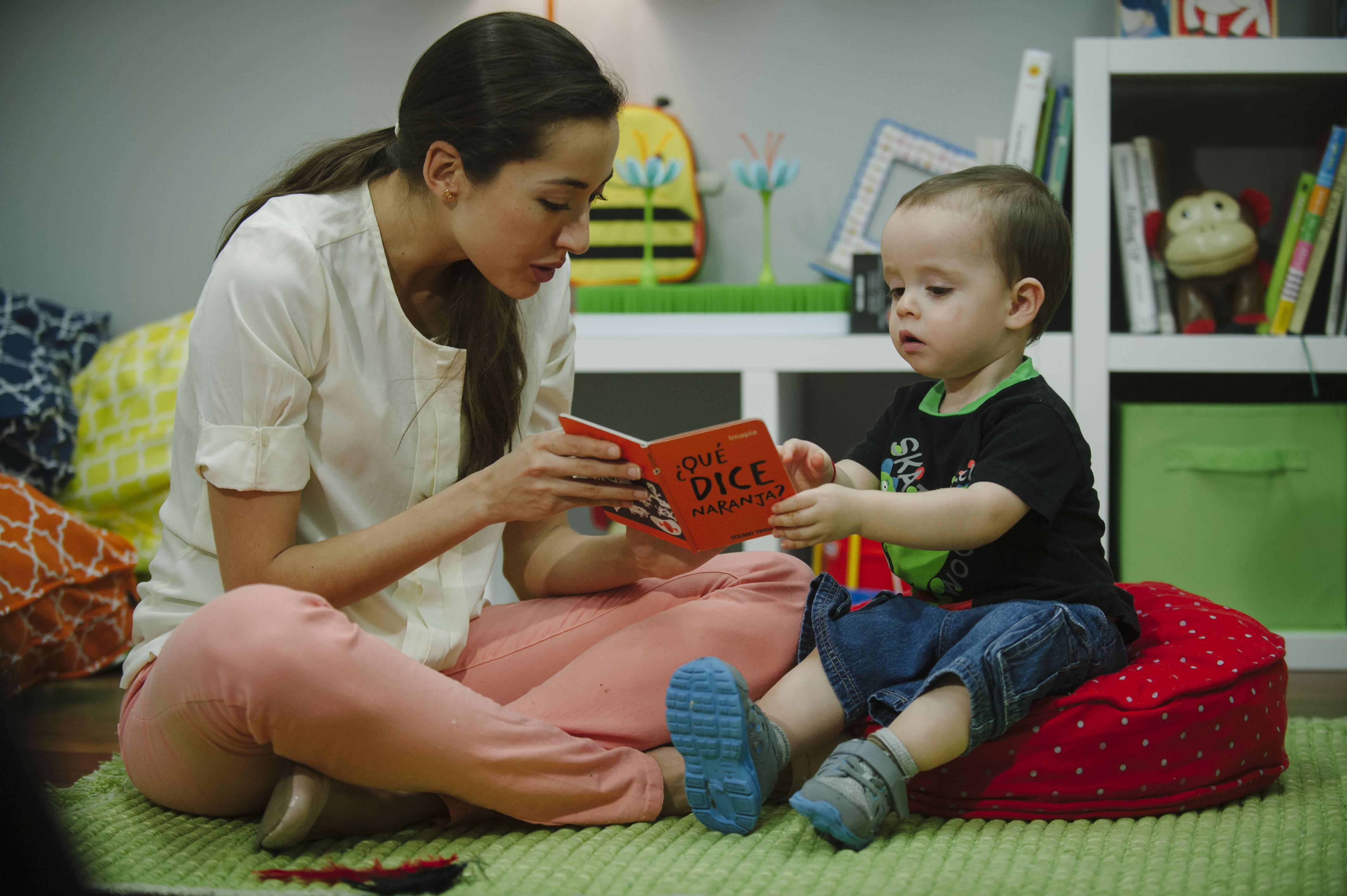 Mom and toddler reading a children's book