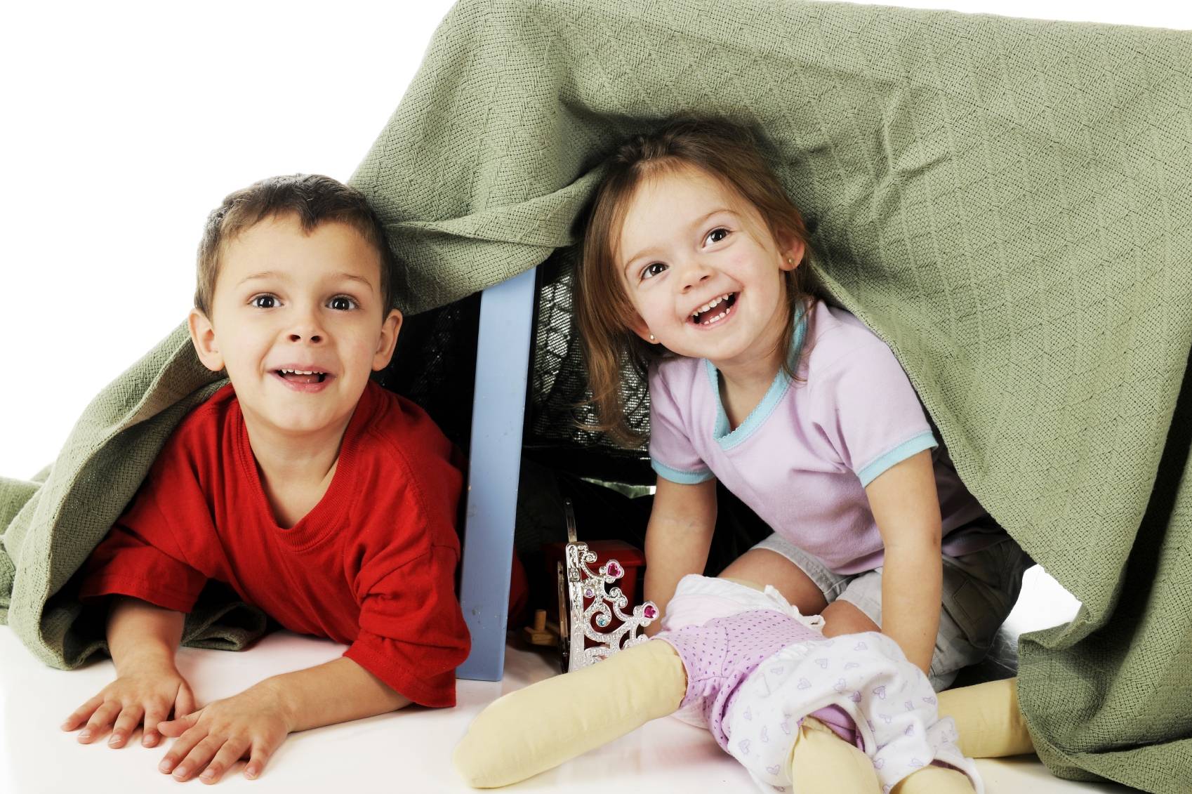 brother and sister playing under a fort of blankets