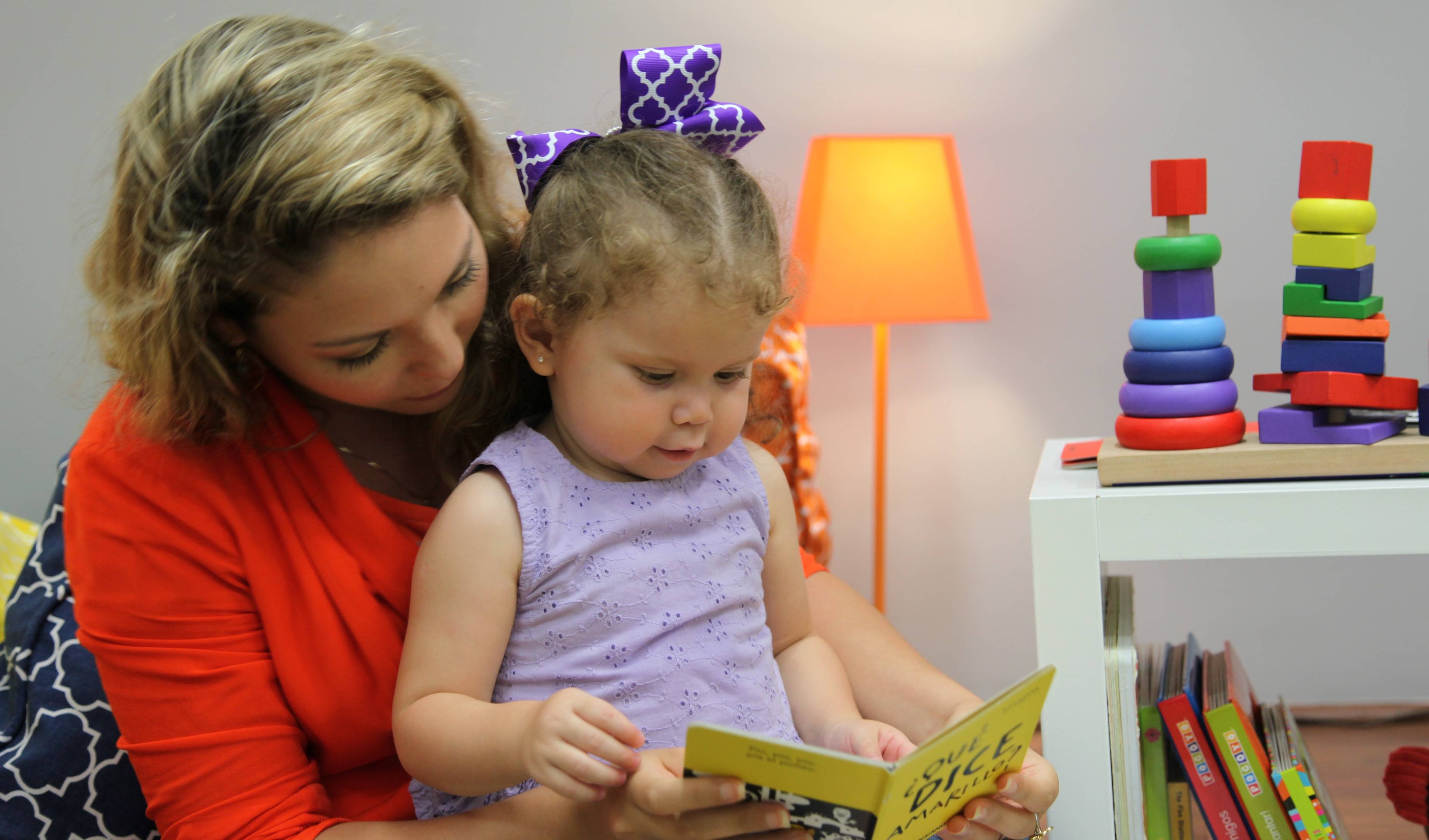 mom and daughter reading a book that teach self-control