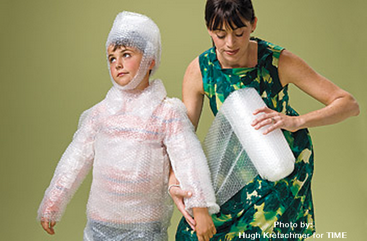 mother protecting her son from failure with bubble wrap