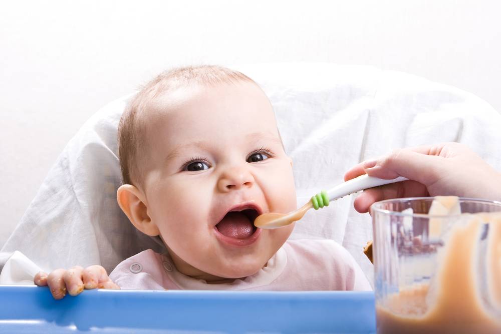 baby being fed with a spoon