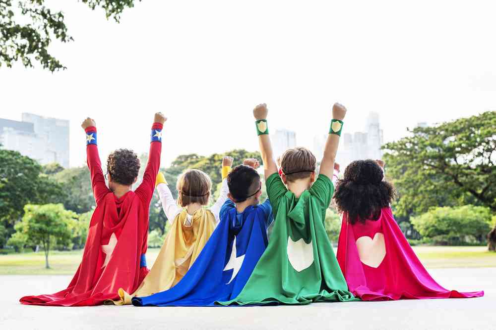 kids wearing superhero capes