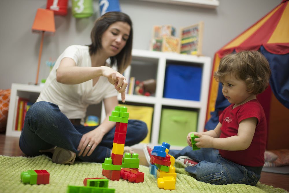 mom and little boy playing with blocks