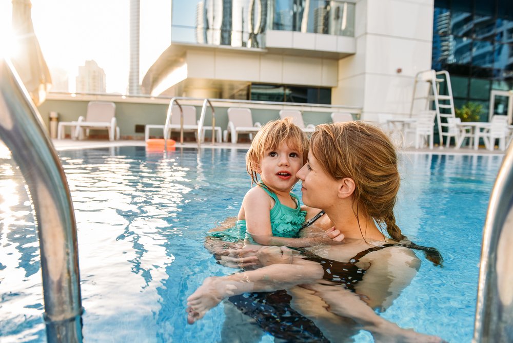woman with little girl in a pool