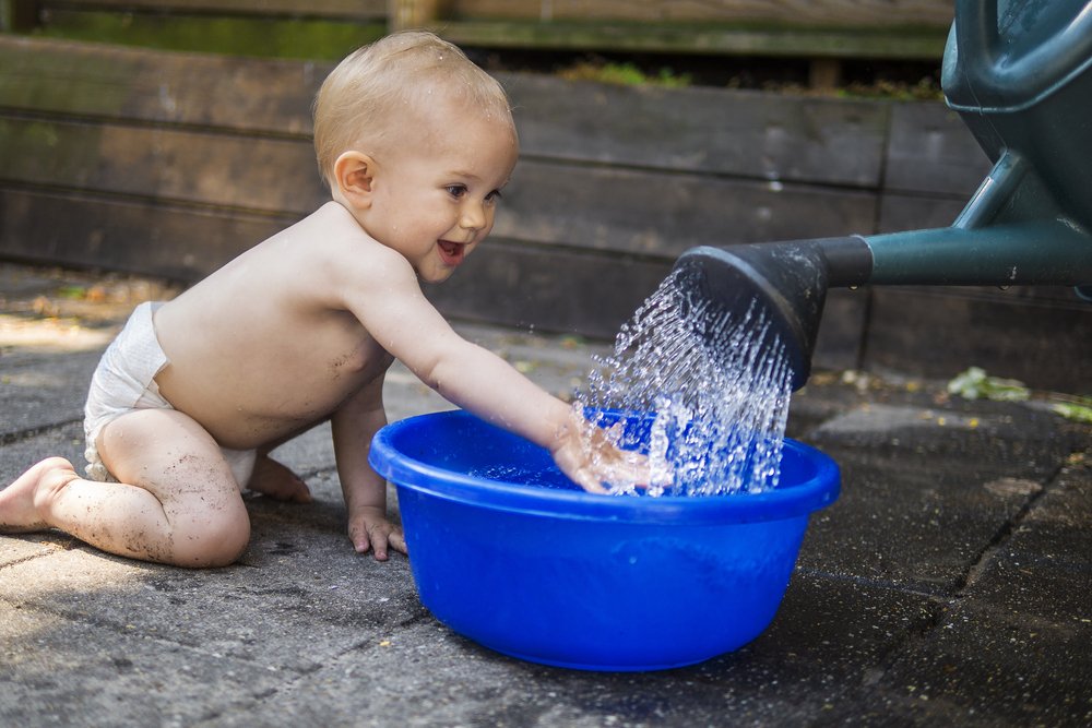 baby playing with water
