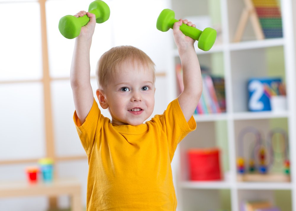 little boy lifting two light weights