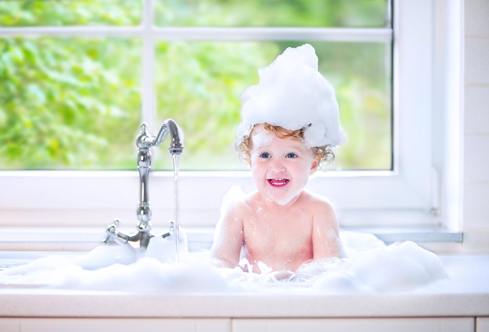 toddler taking a bubble bath
