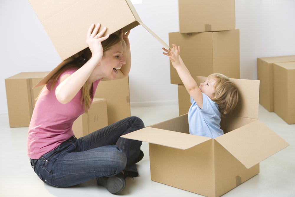 little girl and mom playing with boxes