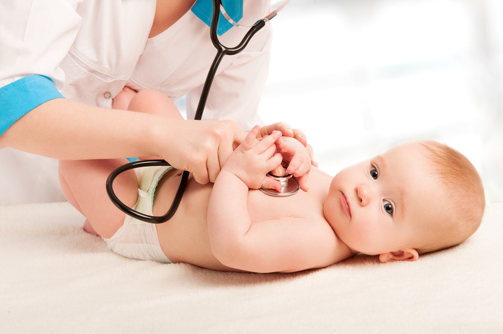 pediatrician checking baby's heart