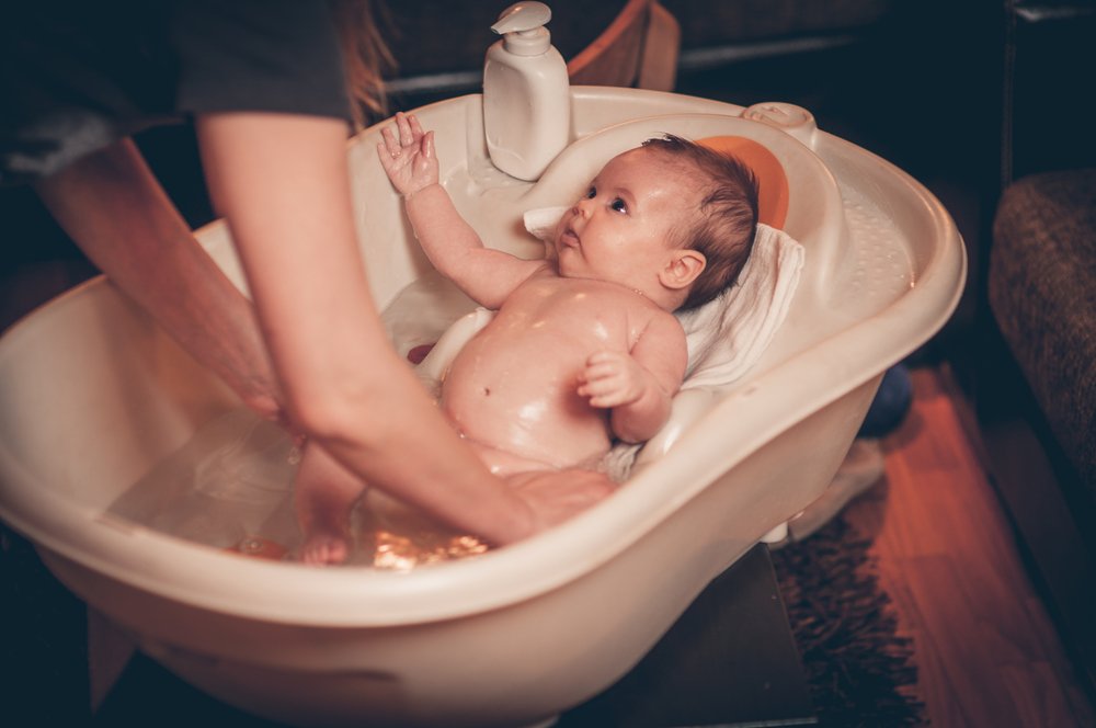 mom bathing her baby