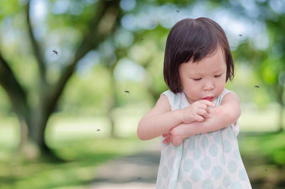 baby girl pointing to an insect bite