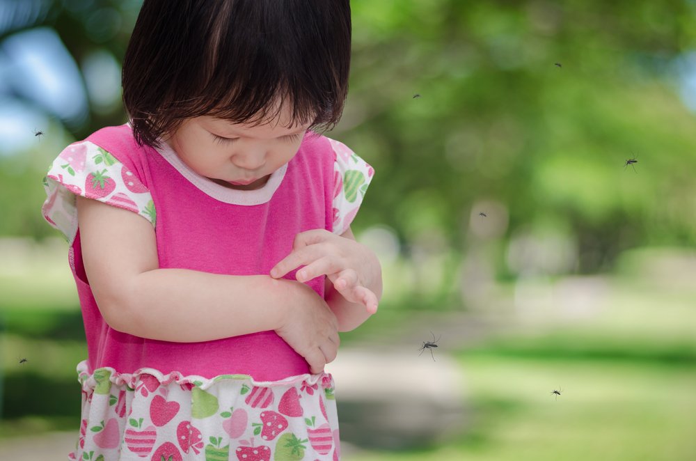 baby girl pointing to an insect bite