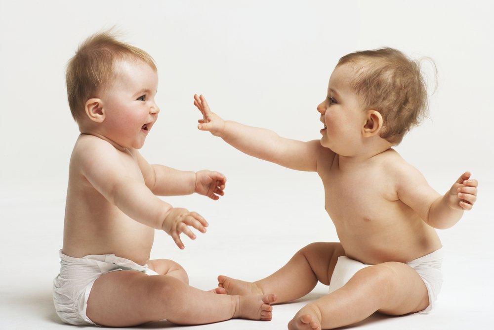 two babies interacting to build social skills