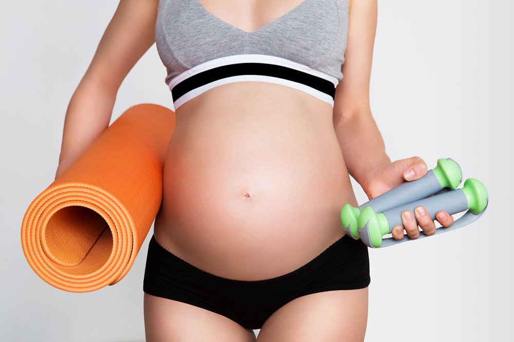 pregnant woman preparing for pilates