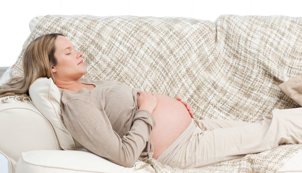 pregnant woman relaxing on a couch