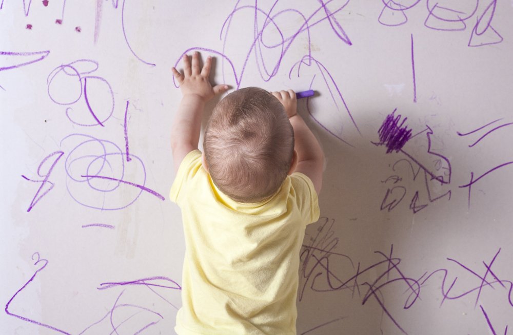 baby scribbling on the wall