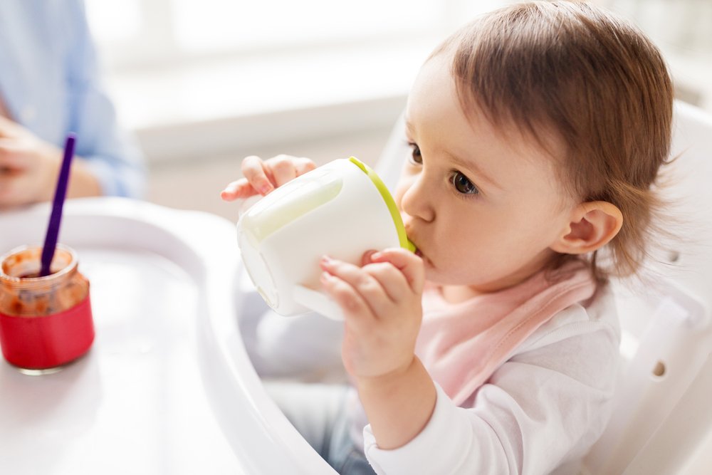 baby girl drinking from a sippy cup