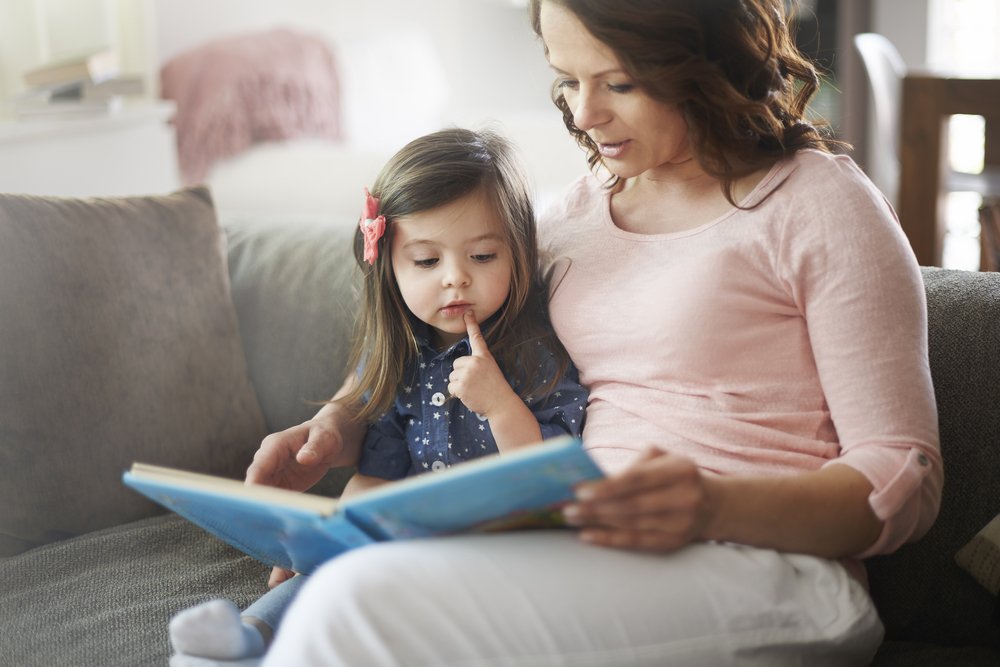 mom and little girl reading a book