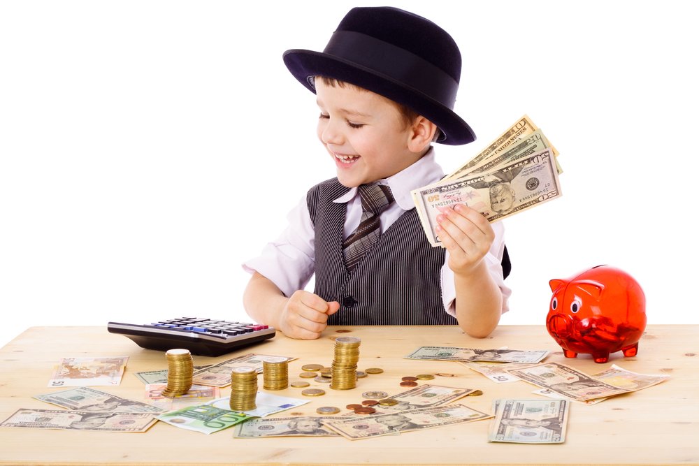 little boy holding money in his hand