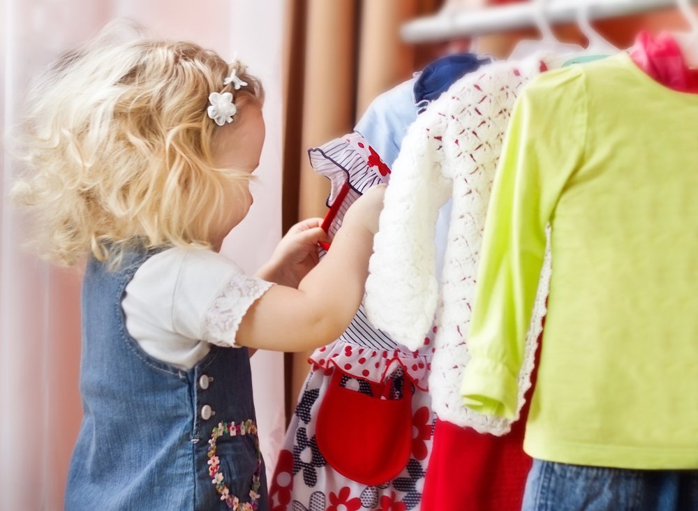 little girl choosing her clothes