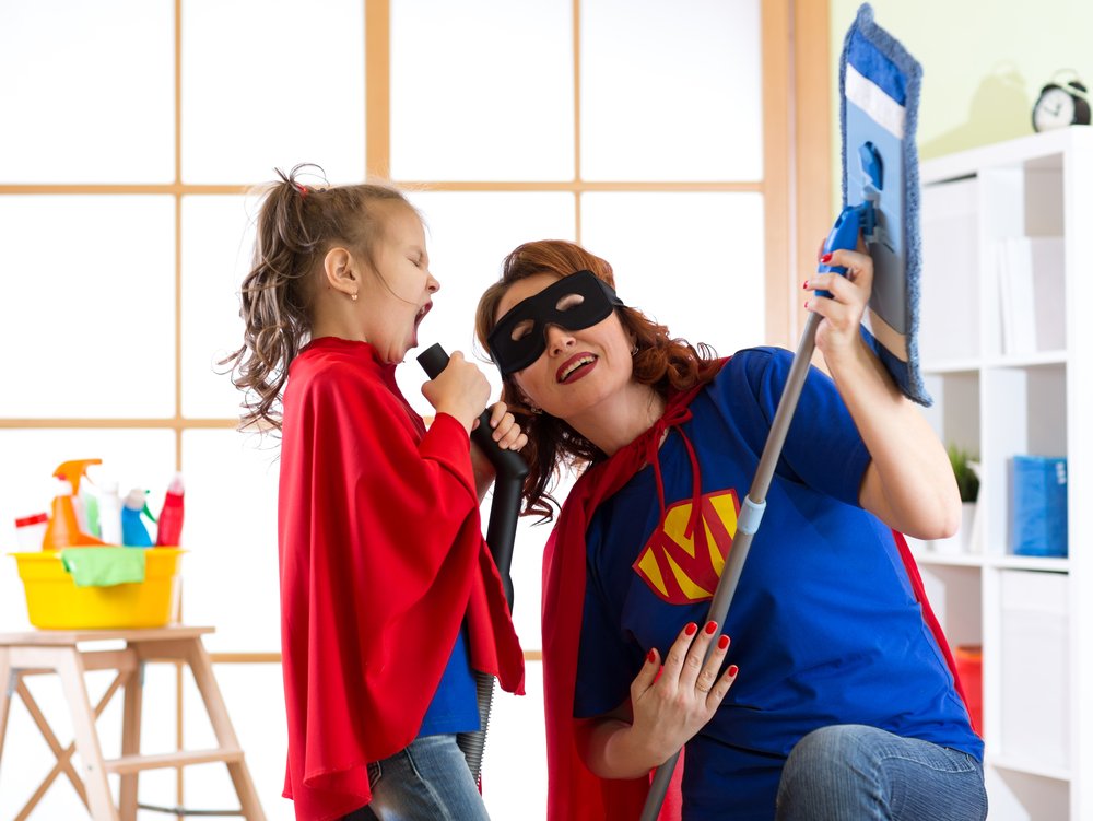 preschooler and mom singing while dressed as superheroes