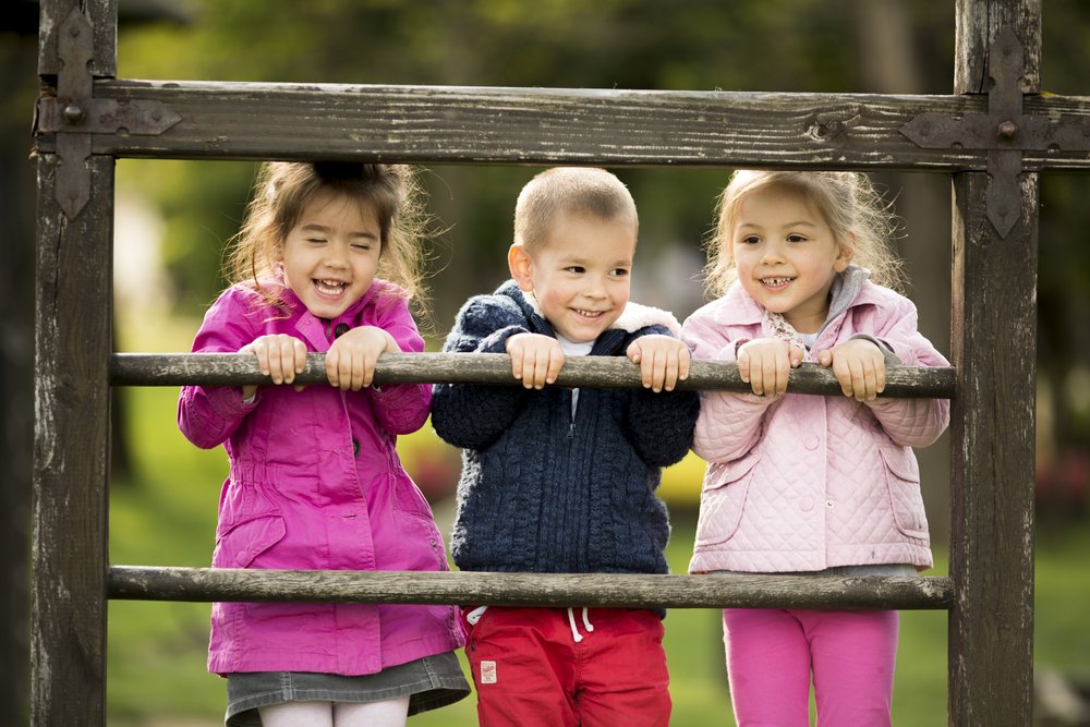 three small children smiling