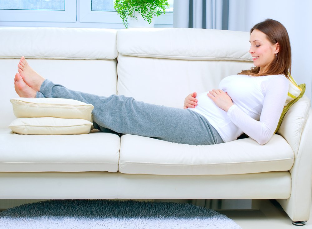 pregnant woman relaxing an the couch