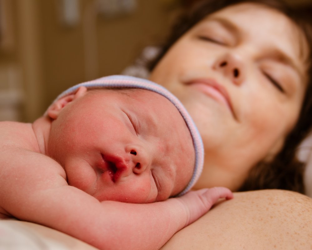sleeping woman and newborn