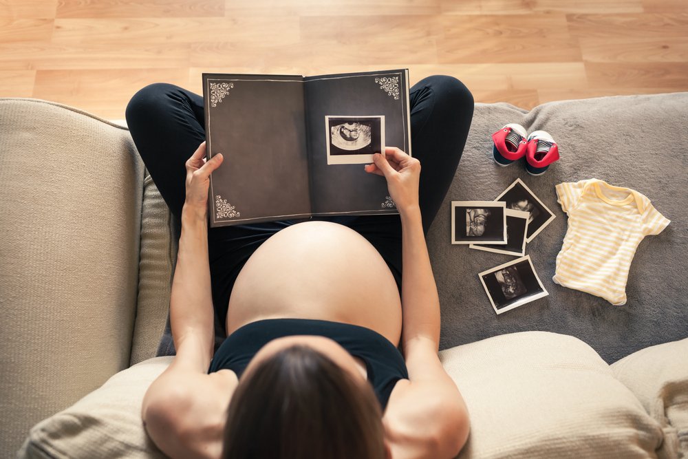 pregnant woman starting a baby photo album