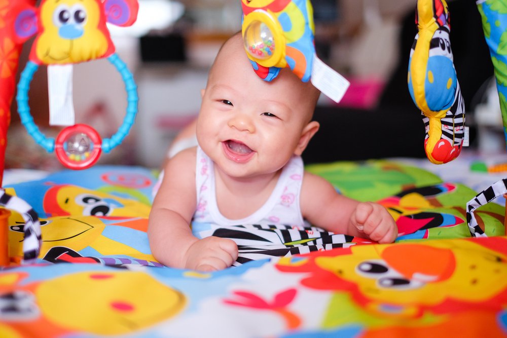 smiling baby while doing tummy time