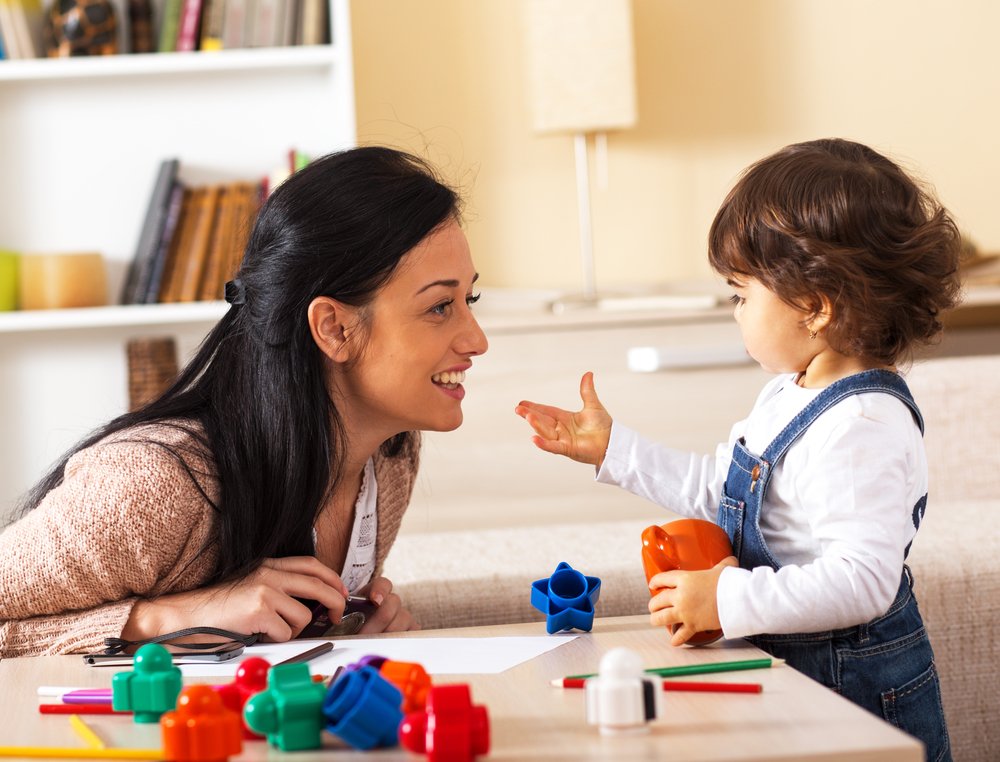 baby shows something to mom