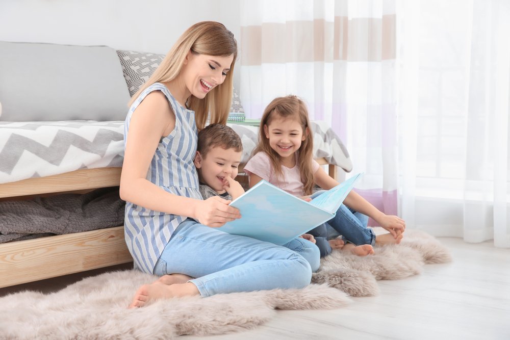 two siblings and mom reading a book