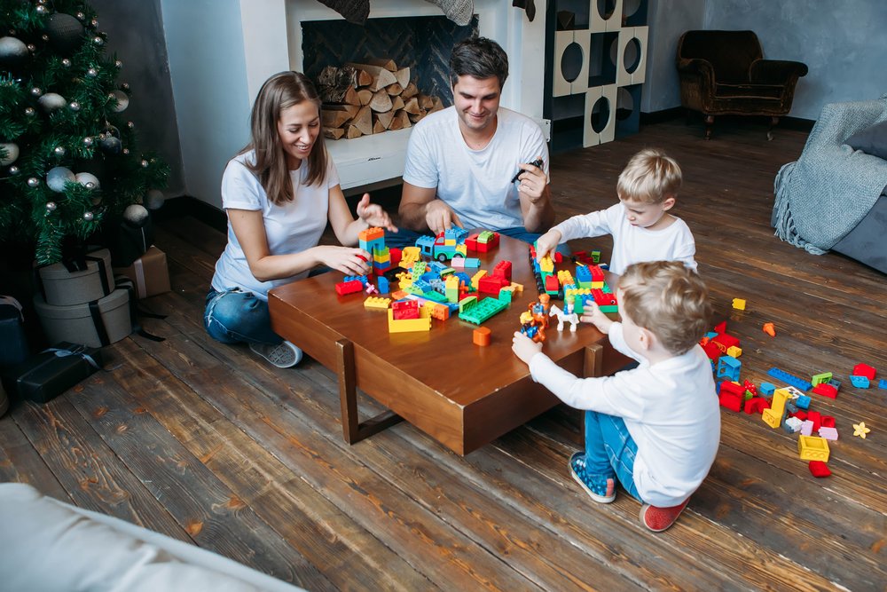 parents and their sons playing together with blocks