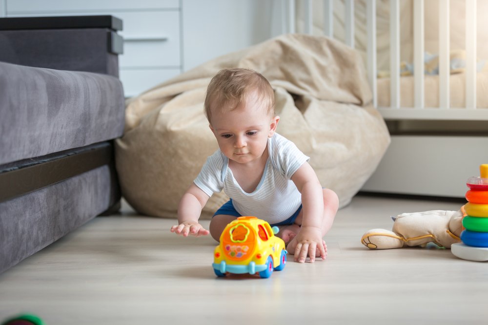 baby crawling after a toy
