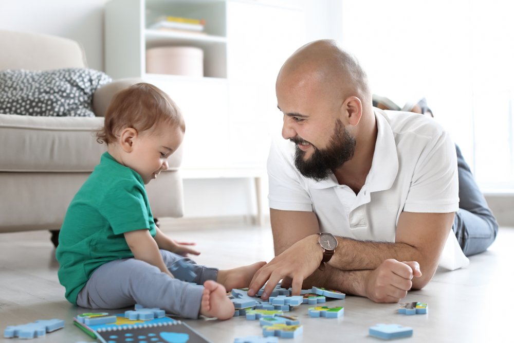 baby and father playing together