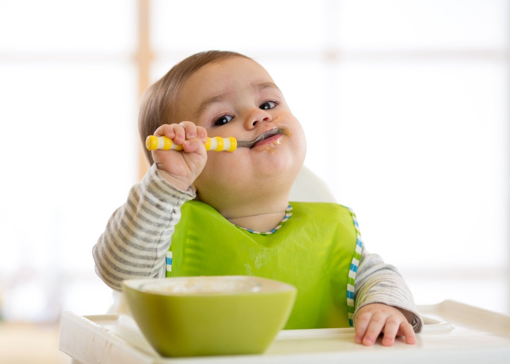baby self-feeding with a spoon