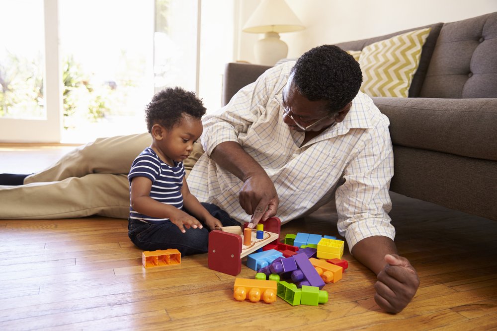 father and baby boy playing with blocks i