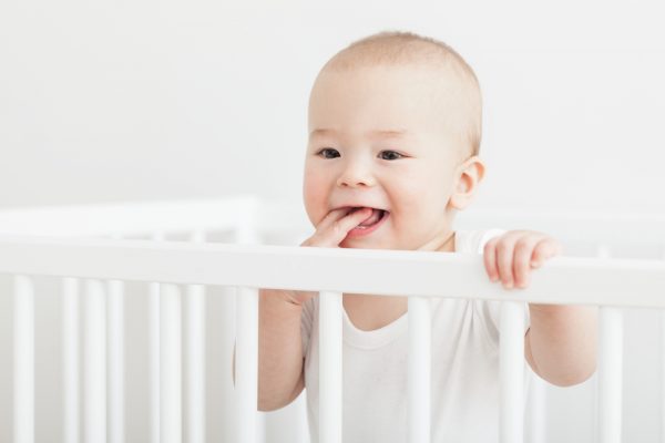 baby pulls up to stand in his crib