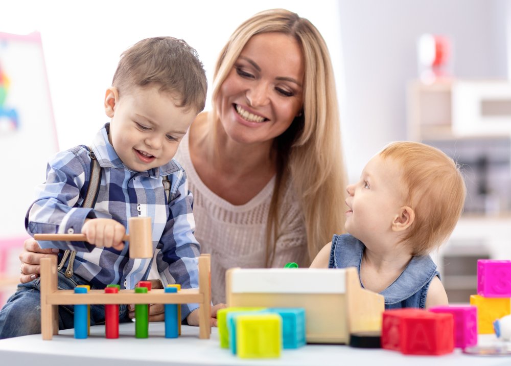 Woman and two toddlers playing together